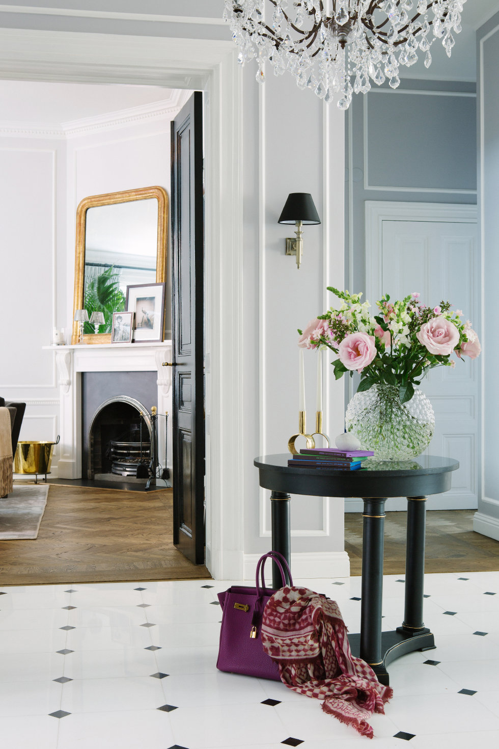 I love the round entry table and black and white theme in this photo from This is Glamorous.
