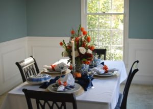 Set an elegant autumn table with this blue and orange color palette. Learn tips to make your fall tablescape gorgeous.