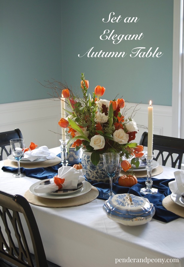 Set an elegant autumn table with this blue and orange color palette. Learn tips to make your fall tablescape gorgeous.