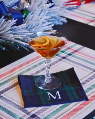 Sit by the fire and enjoy all the tastes of Christmas in this holiday martini made with bourbon, amaretto, and vanilla clove syrup.