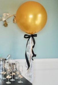 Invite girlfriends over for a glamorous Golden Globes party. Get inspired with these party ideas featuring DIY popcorn cones, gold balloons, and tassel garland.