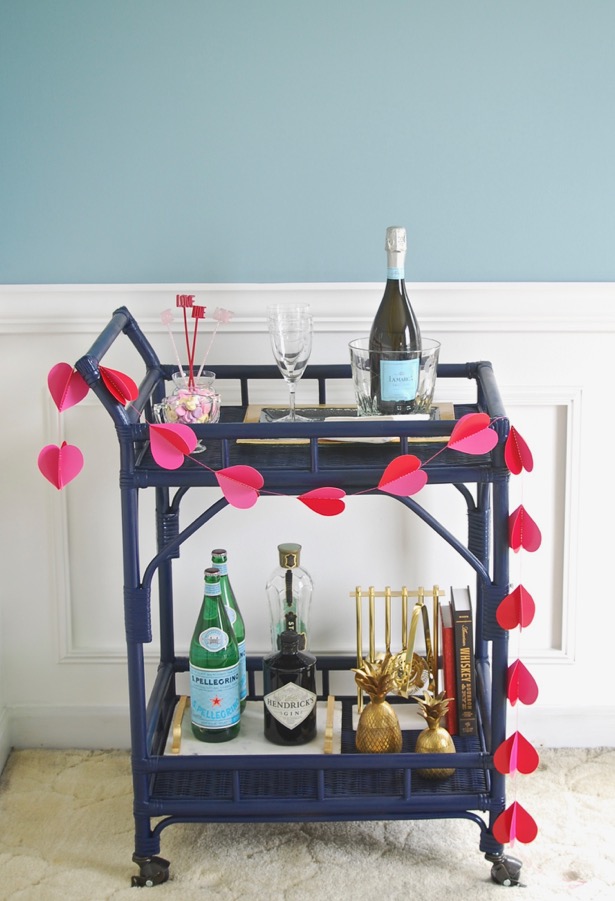 Celebrate your gal pals this weekend with this inspirational Galentine's Day Brunch tablescape + bar cart! Decorate in pink and white with a gorgeous floral garland and fun conversation hearts.