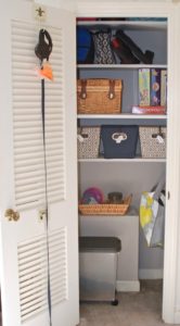 Entryway closet organized with added shelves and bins