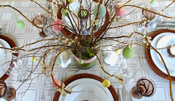 Set a sophisticated Easter table with pastel details and rustic elements.