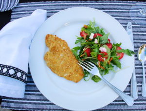 Almond crusted flounder with a strawberry arugula salad are sure to please summer party dinner guests.
