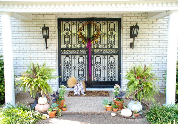 Elevate your curb appeal by adding autumn charm at the front door with punches of purple, heirloom pumpkins, terra cotta pots, fall plants, and festive ferns.