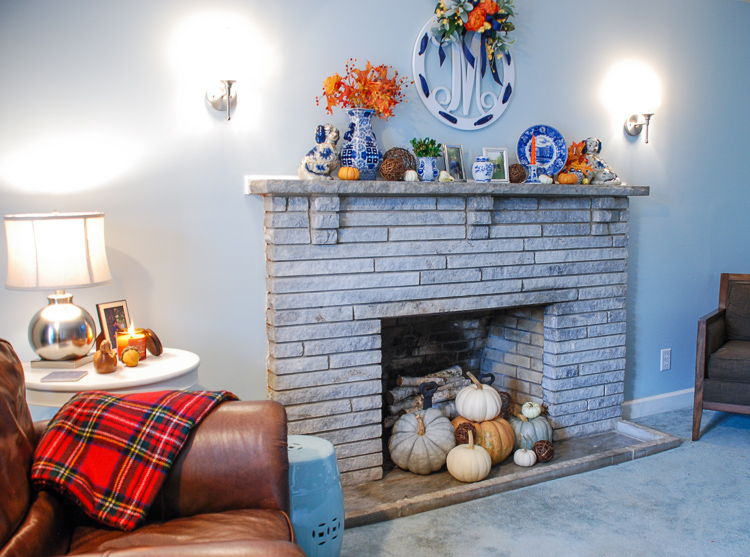 Decorate for autumn with a cheery blue and white fall mantel adorned with mini pumpkins, fall foliage, Staffordshire spaniels, monograms, and blue and white china!