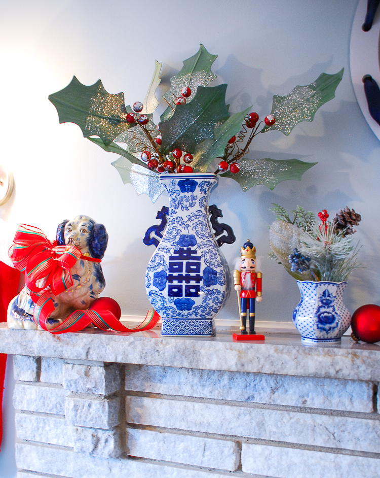 Transition your blue and white mantel decor from fall to Christmas in just a few easy steps with pops of a seasonal accent color. Switch the orange for red and decorate for two seasons with little effort!