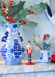 Transition your blue and white mantel decor from fall to Christmas in just a few easy steps with pops of a seasonal accent color. Switch the orange for red and decorate for two seasons with little effort!