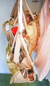 Repurpose grocery store wine totes as storage caddies to organize your closet, bathroom, and suitcase!