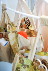 Repurpose grocery store wine totes as storage caddies to organize your closet, bathroom, and suitcase!