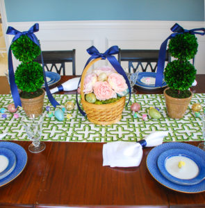 Set a bright and colorful Easter tablescape with a blooming Easter basket and boxwood topiaries for a whimsical centerpiece + get my recipe for pesto asparagus and poached egg!