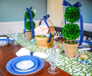 Set a bright and colorful Easter tablescape with a blooming Easter basket and boxwood topiaries for a whimsical centerpiece + get my recipe for pesto asparagus and poached egg!