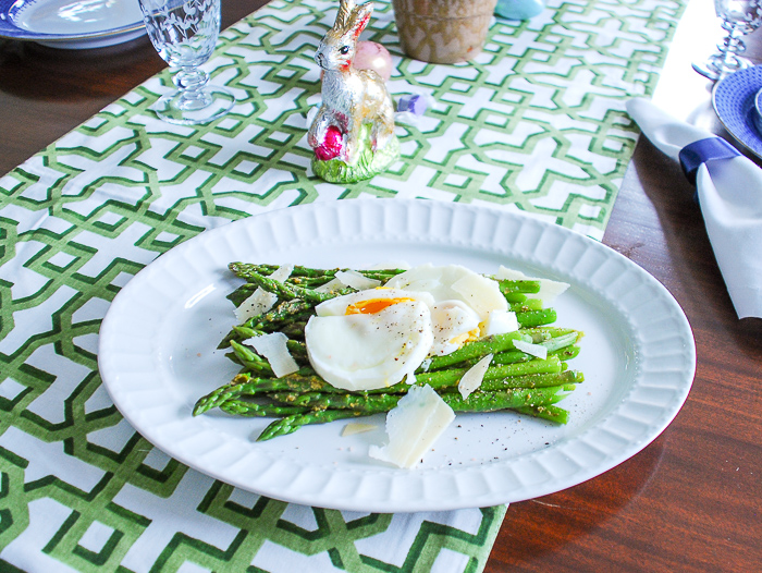 Set a bright and colorful Easter tablescape with a blooming Easter basket and boxwood topiaries for a whimsical centerpiece + get my recipe for pesto asparagus and poached egg!