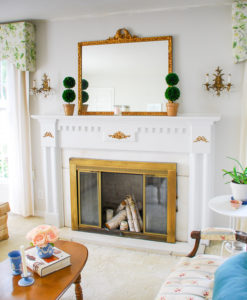 Gingham and chintz harmonize in this traditional living room for a bright and airy space that is full of Chinoiserie details and Southern charm.