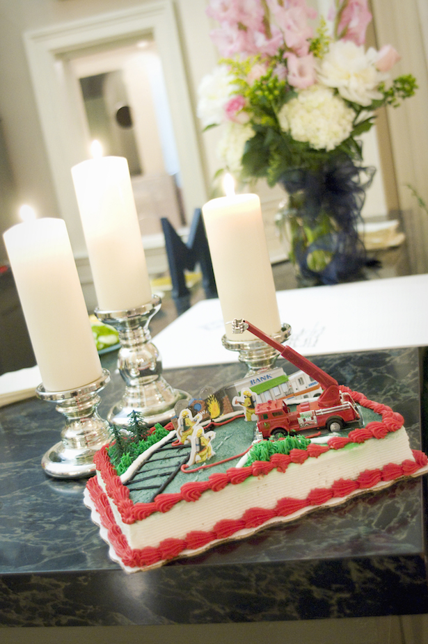 Southern wedding tradition of groom's cake decorated with firefighter toys.
