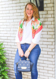 Young blond in preppy wardrobe staples: white oxford, dark wash denims, heels, and scarf.