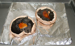 Bake the portobello mushrooms first before filling with sausage stuffing.