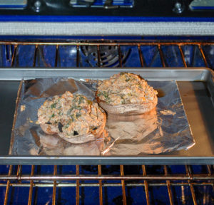 Sausage stuffed portobello mushrooms baking in oven.