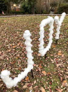PVC joy sign wrapped in tinsel garland - easy DIY outdoor Christmas decoration