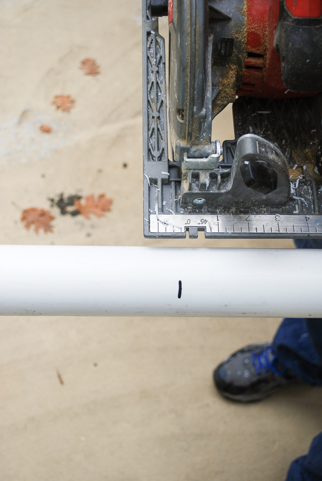 Cut the PVC pipe with a skill saw at measured lengths for this Christmas joy sign DIY