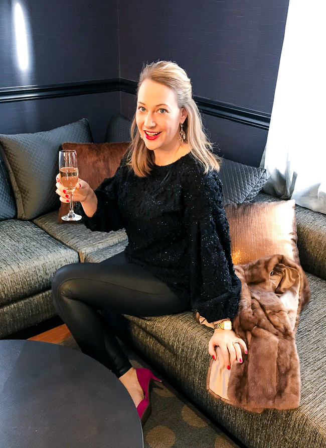 Blonde woman in black and sparkly going out look for NYE