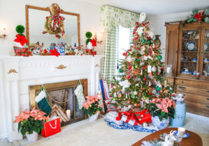 Full view of preppy and plaid Christmas tree with traditional mantel decorated with boxwood, plaid ribbon, and blue and white ceramics