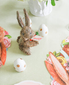 Little straw bunny surrounded by polkadot Easter eggs for a bit of whimsy on this Easter brunch table