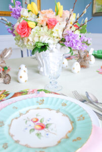Easter brunch table place setting with Hester & Cook bunny placemats and Royal Worcester antique china and pale pink napkin
