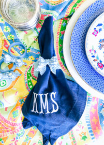 Monogram blue and white napkins add the preppy touch to this summer table