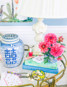 pink dahlias in mini blue and white ginger jar on book stack