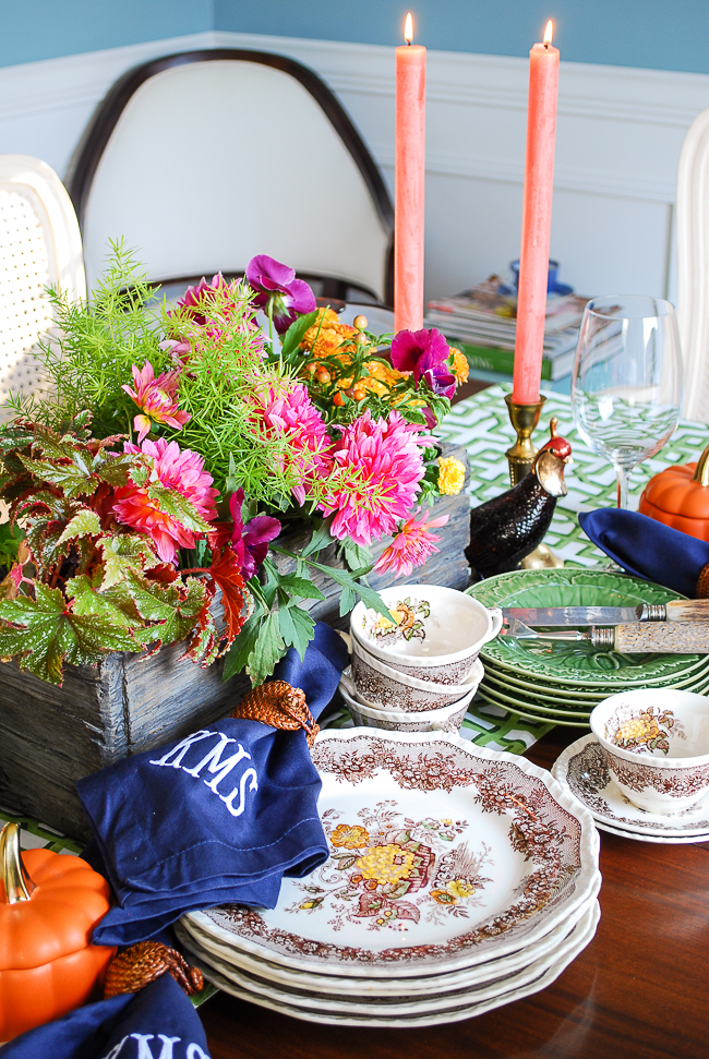 A Southern autumn table set with Mason's china, monogrammed napkins, fall florals, and trellis runner