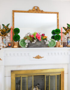 Traditional interior with chic fall mantel decor, gilt mirror, and green gingham curtains