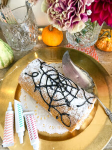 Decorate a pumpkin spice roll with an icing web for that spooky feel