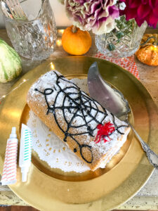Decorate a pumpkin spice roll with an icing web for that spooky feel