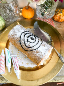 Decorate a pumpkin spice roll with an icing web for that spooky feel