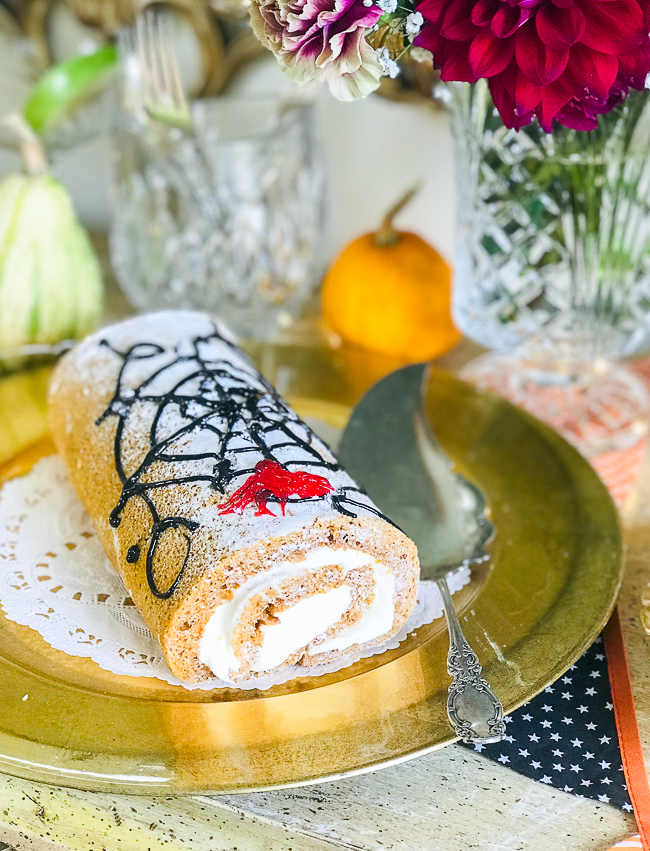 Decorate a pumpkin spice roll with an icing web for that spooky feel