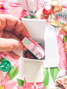 Fill advent mini-present boxes with treats and Christmas activity slips