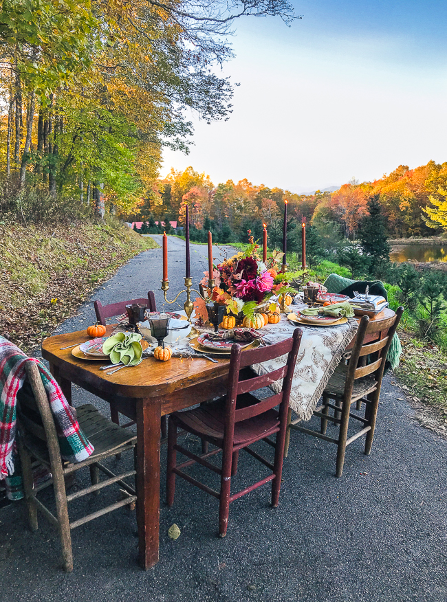 Al fresco Thanksgiving in Blue Ridge Mountains on Christmas tree farm. Set a rustic Chinoiserie Thanksgiving table for 2019 with toile, colorful china, dahlias, and brass.
