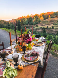 Set a bold, lavish Thanksgiving tablescape this year with brass, colorful flowers, vintage china, and beautiful linens.