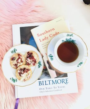 Southern Lady Code and Biltmore Cookbook with cheese and crackers and cup of tea