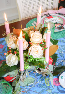 White rose and magnolia floral arrangement in silver swan epergne with pink candles