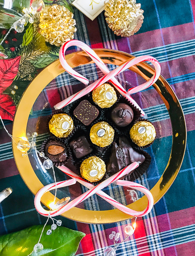 Annie Glass dish from The Pink Daisy filled with Baxley's chocolates, candy canes, and Ferrero Rocher