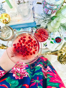 Top view of coupe filled with pomegranate gin cocktail for the holidays