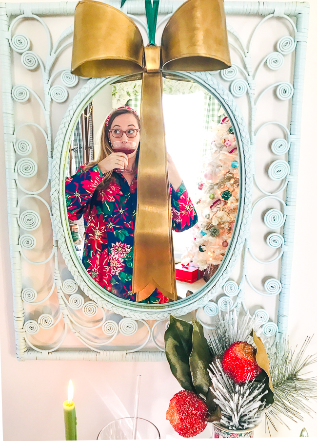 Katherine of Pender & Peony in mirror above holiday bar cart drinking a pomegranate cocktail
