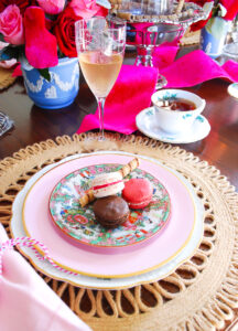 Three tasty macarons served on rose medallion plate