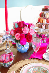 Red and pink roses arranged in blue Wedgwood vase