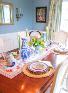 Chinoiserie tablescape with blue and white vases, tobacco leaf ginger jars, tulips, and candlelight