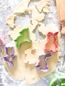 Rolled out sugar cookie dough with spring cookie cutters