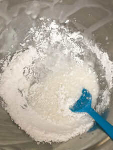 Stirring the icing for sugar cookies